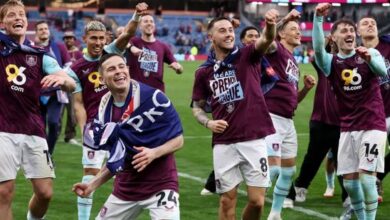 A jubilant burnley squad celebrates their promotion at Elland Road.